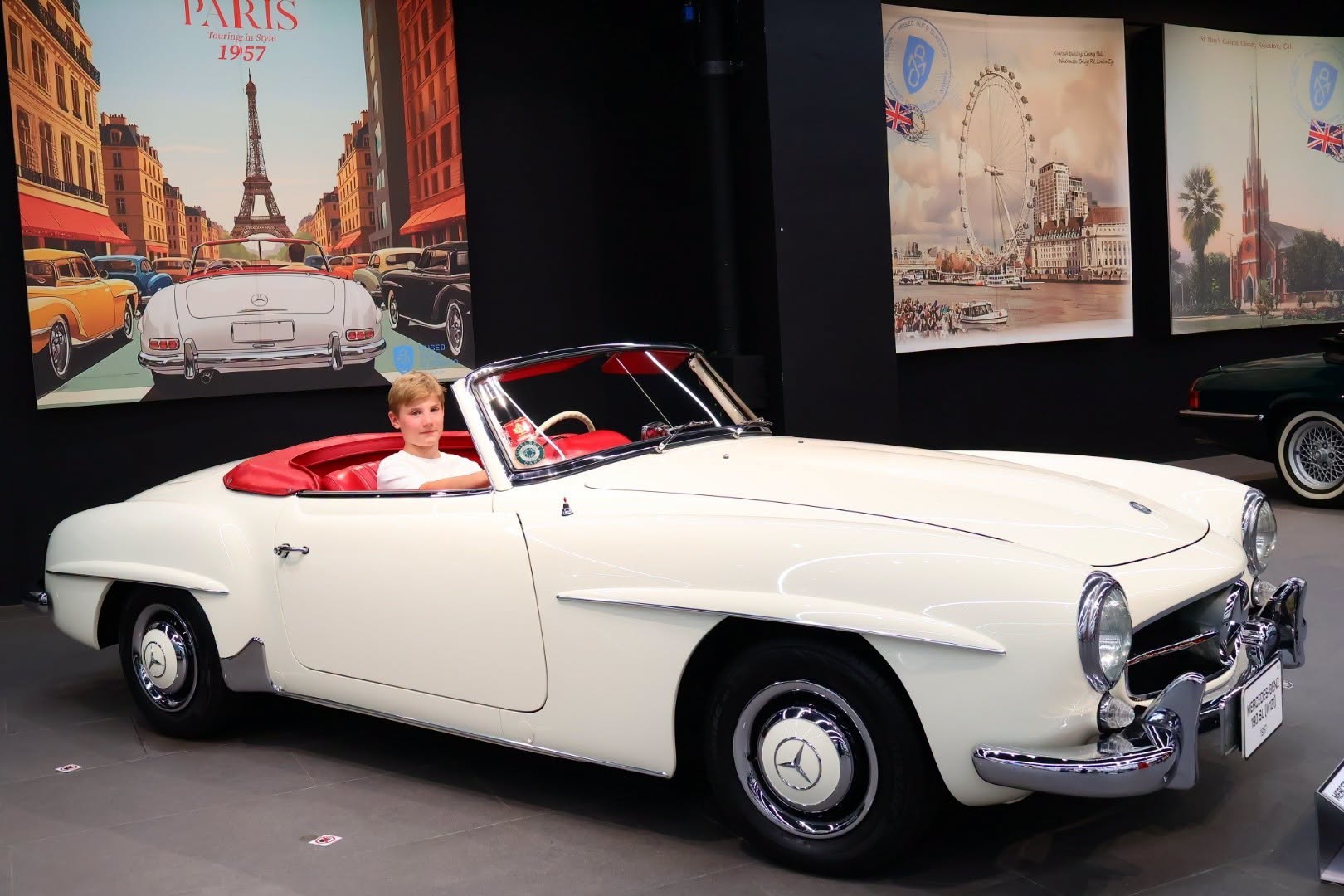 white convertible with red interior in museum